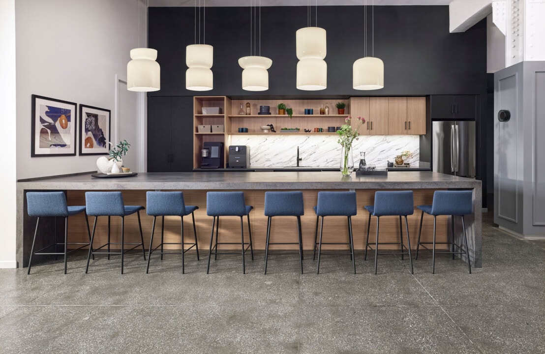 AIS NYC showroom breakroom with dark Caseworks cabinetry, marble backsplash and Devens bar stools